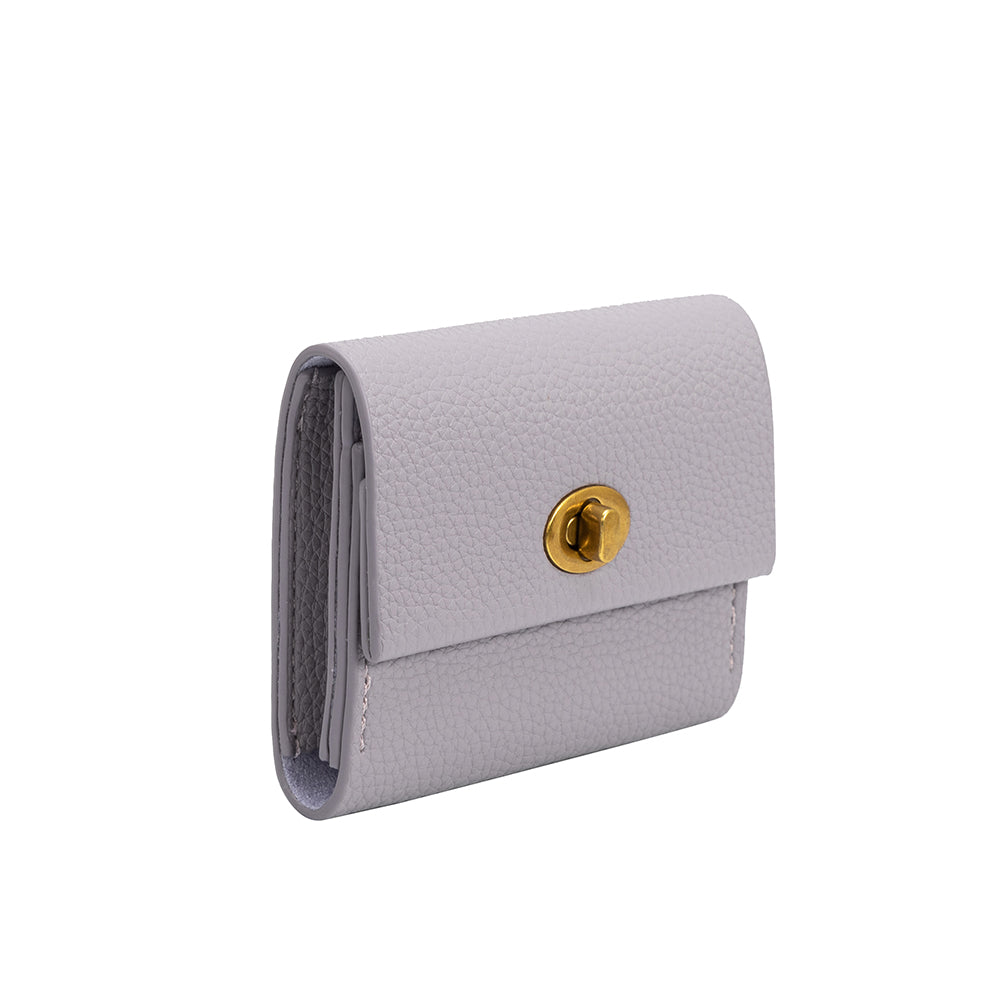 A small lilac pebble vegan leather card case wallet with a gold clasp.