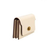 A small ivory vegan leather card case wallet with a gold clasp. 