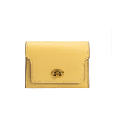 A small yellow vegan leather card case wallet with a gold clasp. 