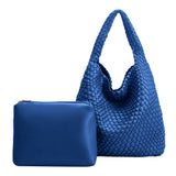 A large cobalt woven vegan leather shoudler bag with a zip pouch inside