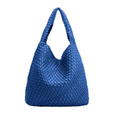 A large cobalt woven vegan leather shoulder bag with a zip pouch inside