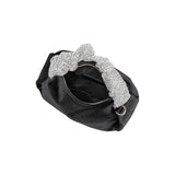 A medium velvet black top handle bag with a silver encrusted handle. 