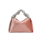 A medium velvet blush top handle bag with a silver encrusted handle. 