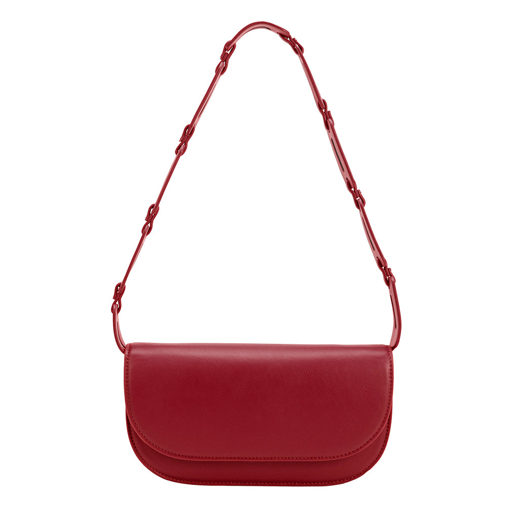 A small red vegan leather shoulder bag with a scalloped strap.