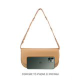 An iphone 11 size comparison image of a small vegan leather shoulder bag with a scalloped strap.