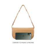 An iphone 11 size comparison image of a small vegan leather shoulder bag with a scalloped strap