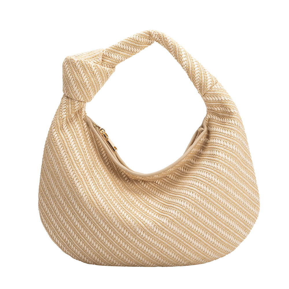 A large natural woven straw shoulder bag with a knot handle