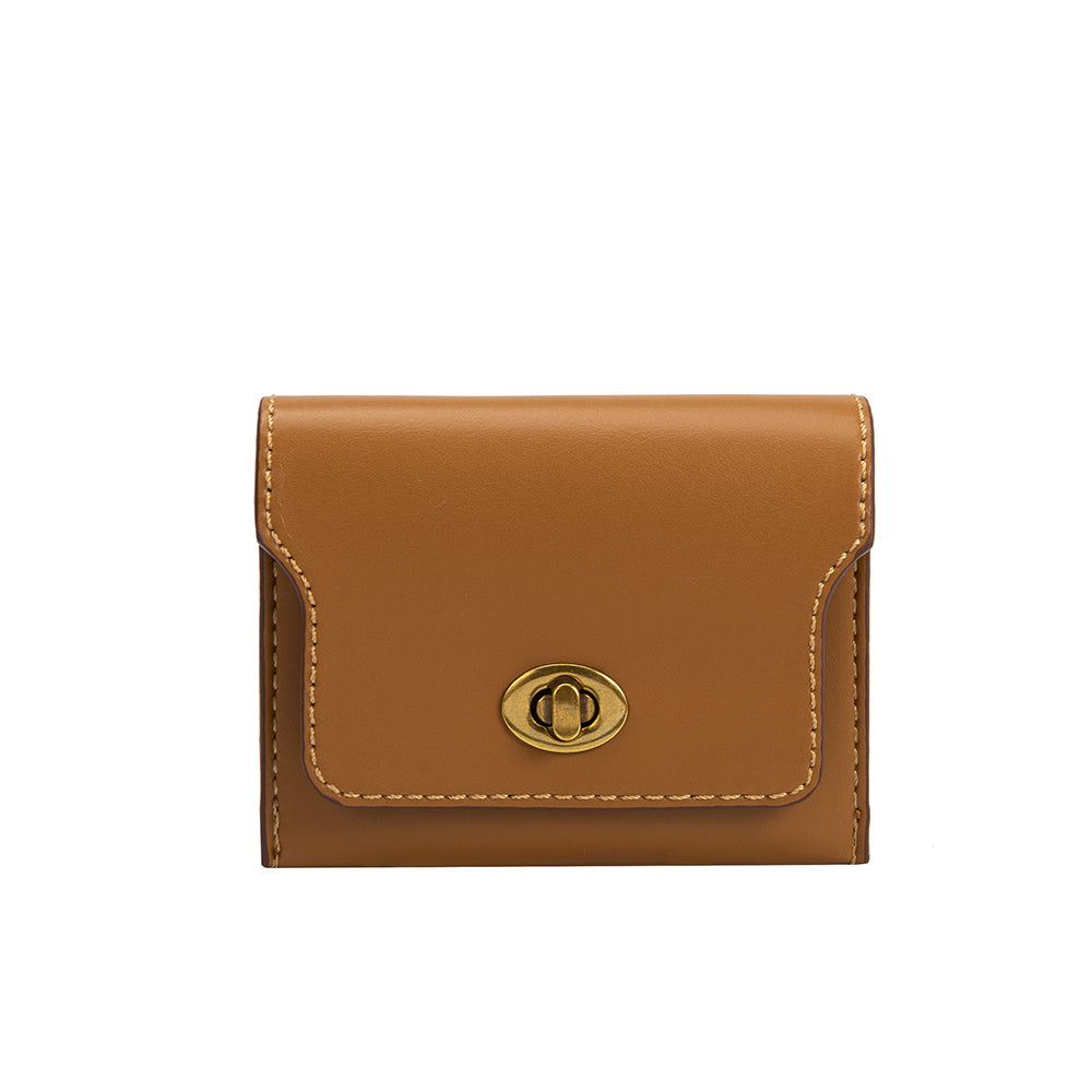 A small tan vegan leather card case wallet with a gold clasp.