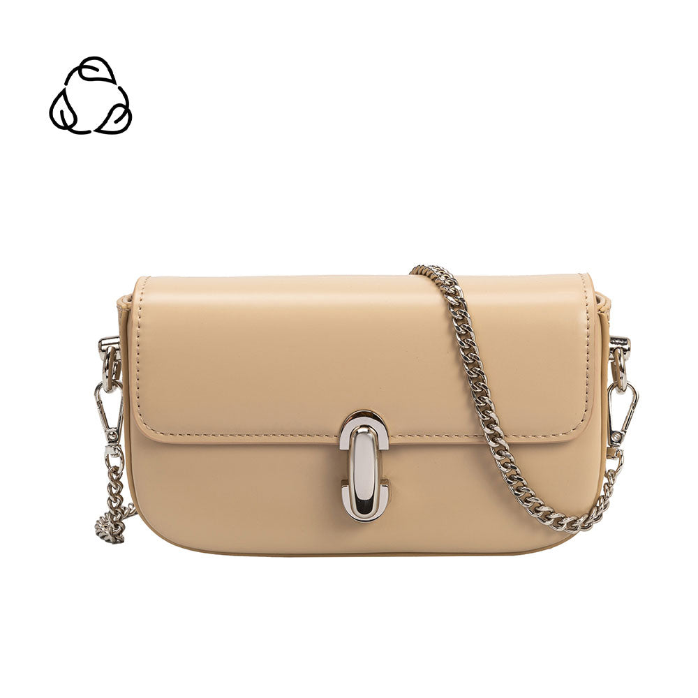 A mini nude vegan leather crossbody bag with a silver clasp closure.