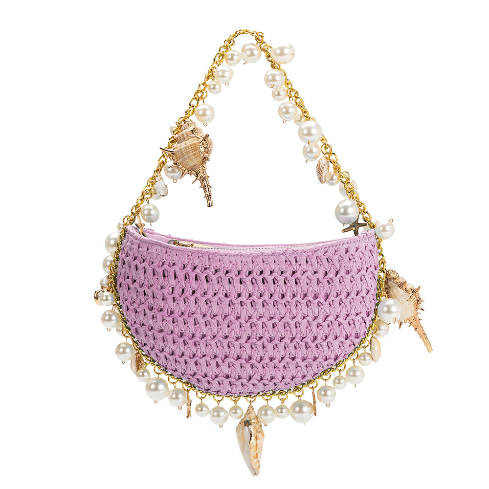 A small lavender crochet straw top handle bag with seashell detail along the handle.