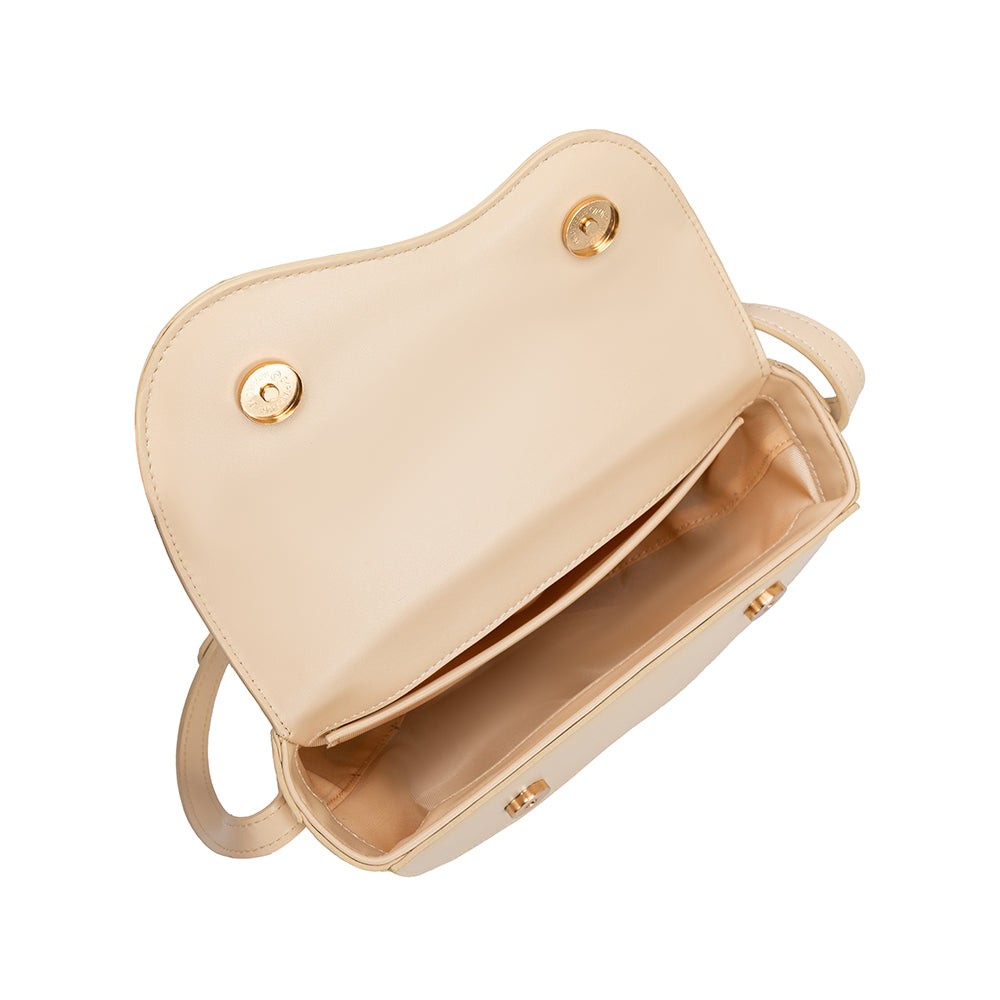 A small nude vegan leather crossbody bag with a wavy front flap closure.