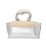 A small metallic and nude vegan leather top handle bag with a wavy front flap closure.