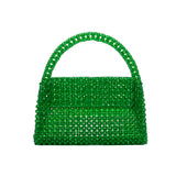 A small emerald crystal beaded top handle bag with a flap closure.