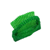 A small emerald crystal beaded top handle bag with a flap closure.