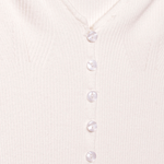 A detail image of a white long sleeve rib knit cardigan with buttons. 