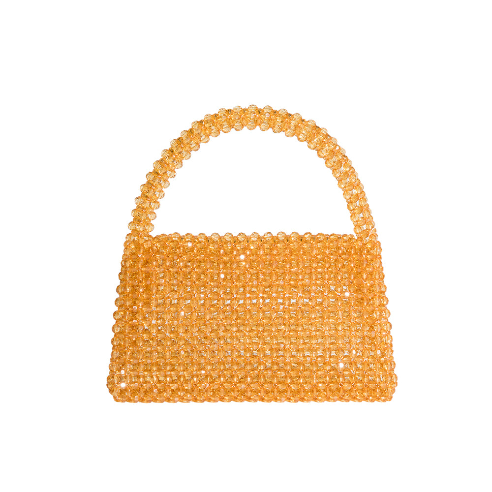 A small citrine crystal beaded top handle bag with a flap closure.