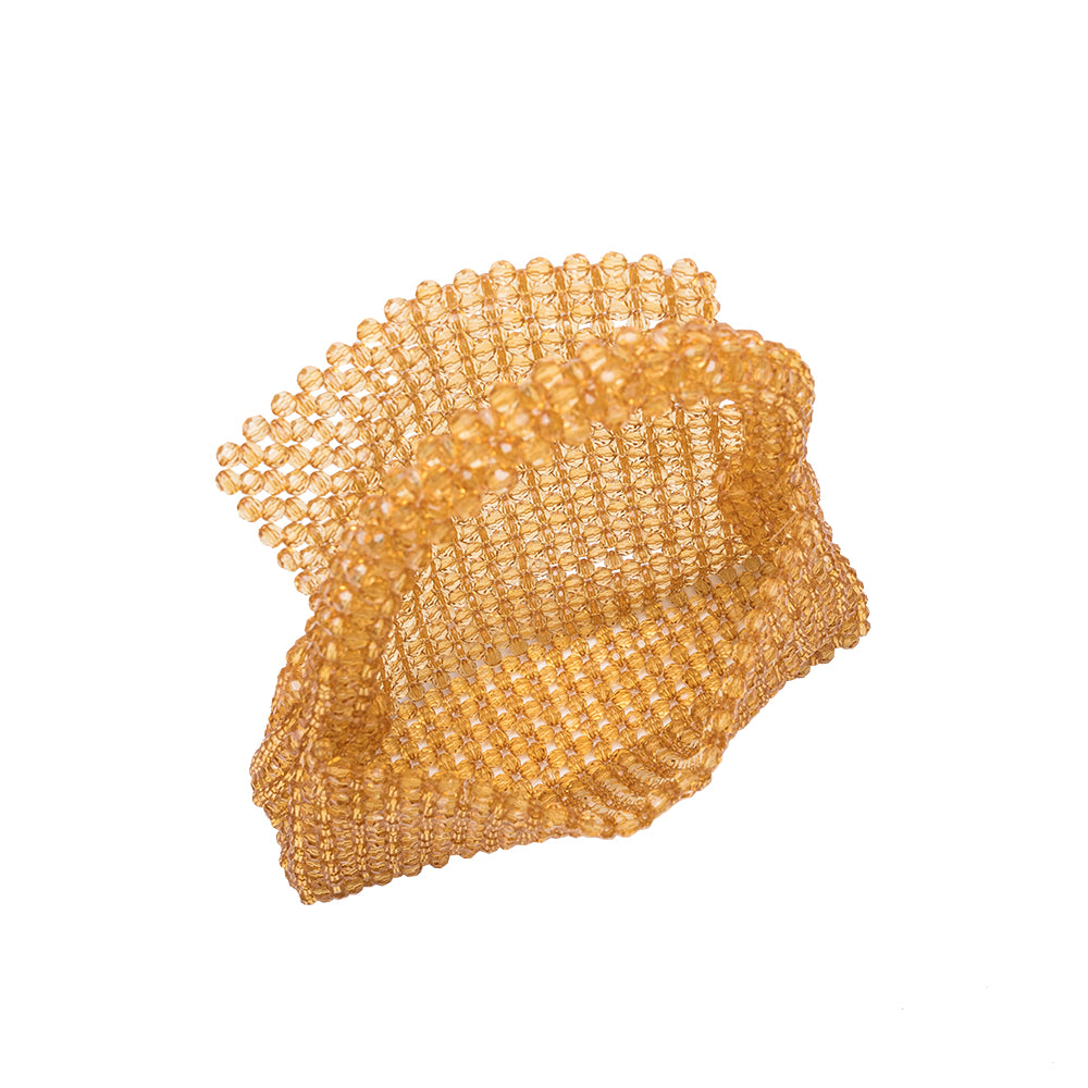 A small citrine crystal beaded top handle bag with a flap closure.