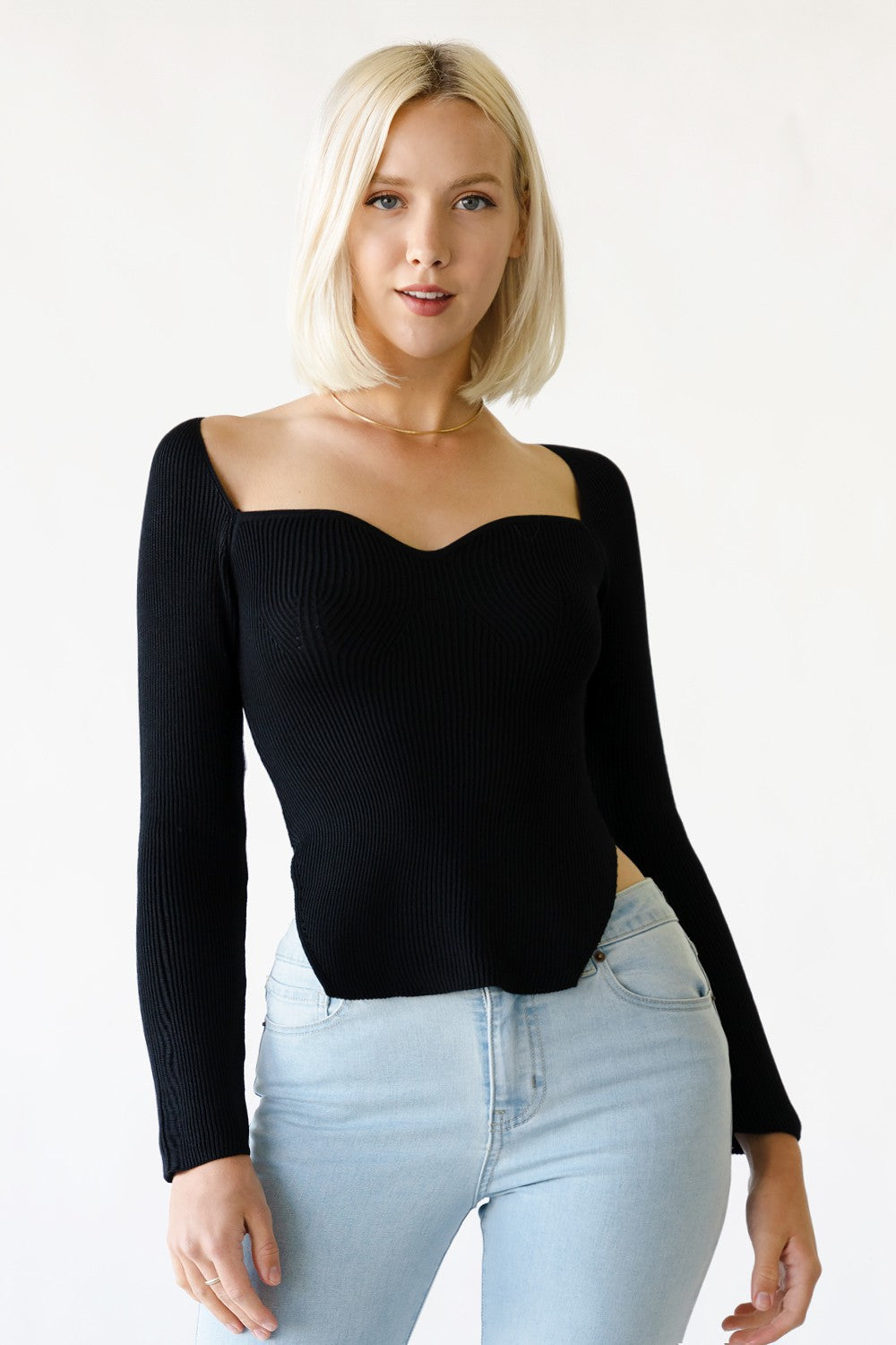 a model wearing a sweetheart neckline rib knit longsleeve top. 