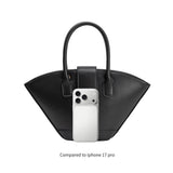 Black handbag compared to iPhone 17 Pro on a white background