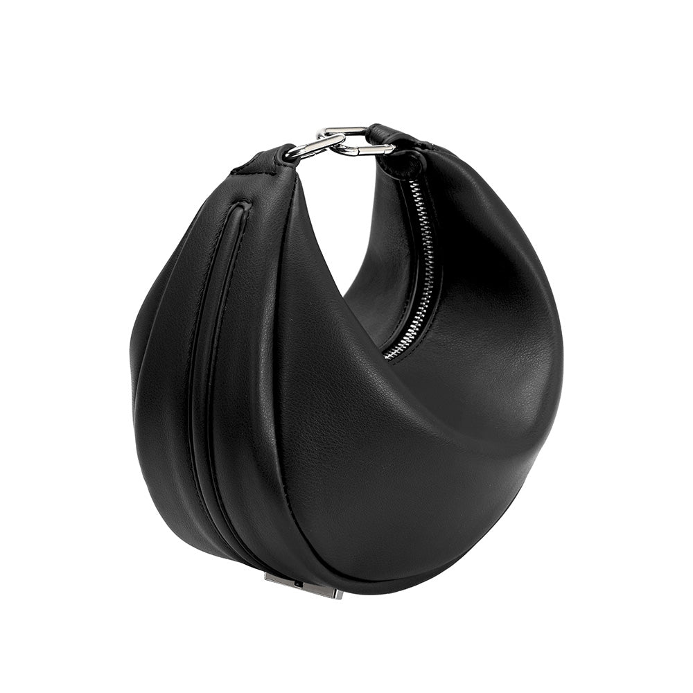 A black crescent shaped vegan leather crossbody bag with silver hardware. 