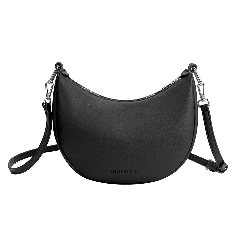 A black crescent shaped vegan leather crossbody bag with silver hardware. 