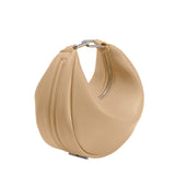 A nude crescent vegan leather crossbody bag with silver hardware. 