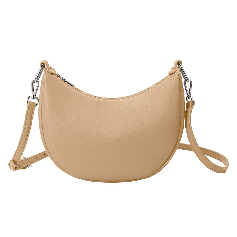 A nude crescent vegan leather crossbody bag with silver hardware. 