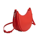 A red crescent vegan leather crossbody bag with silver hardware. 