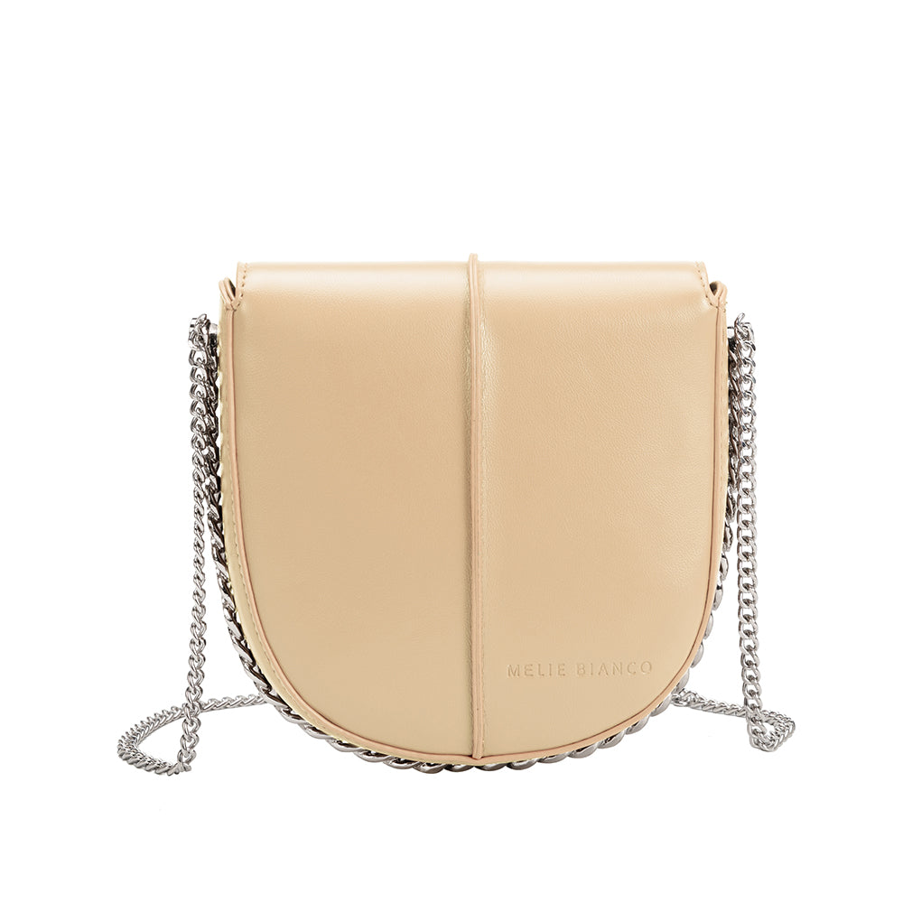 A nude vegan leather crossbody handbag with silver handle. 