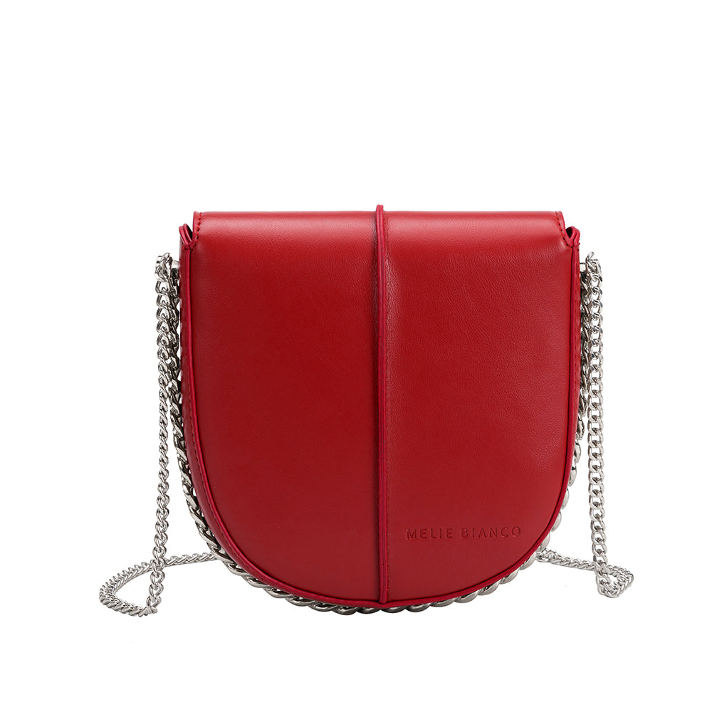 A red vegan leather crossbody handbag with silver handle.