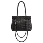 A black hand woven vegan leather crossbody bag with curved handle. 