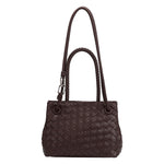 A espresso hand woven vegan leather crossbody bag with curved handle. 