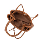 A tan hand woven vegan leather crossbody bag with a curved handle. 