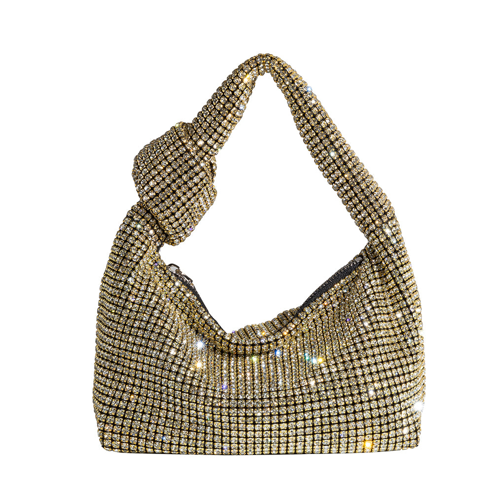 A small gold crystal encrusted top handle bag with a knot.