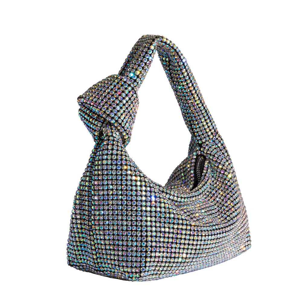 A small multi-colored crystal encrusted top handle bag with a knot.