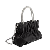 A mini velvet vegan leather top handle bag with a silver encrusted handle. 