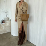 A model wearing a small recycled vegan leather tote bag against a white wall. 