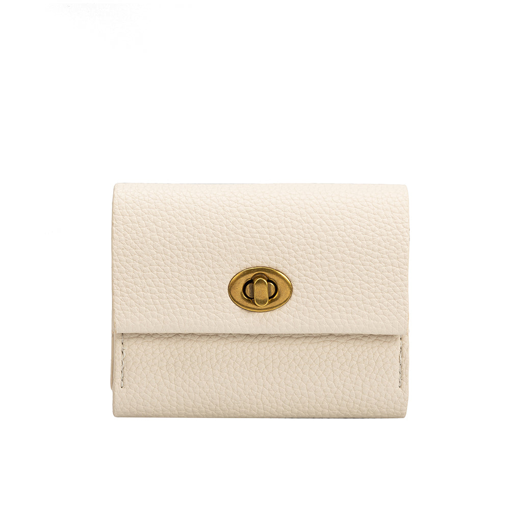 A small ivory pebble vegan leather card case with a gold clasp. 