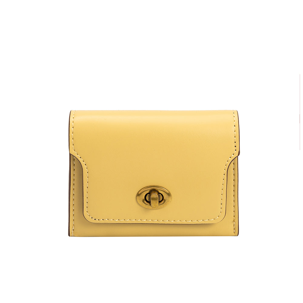 A small yellow vegan leather card case wallet with a gold clasp. 