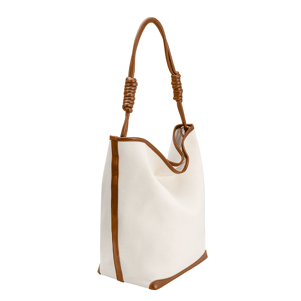 A large canvas tote bag with tan trimming and knotted handle.