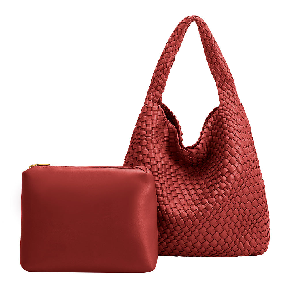 A large red woven vegan leather shoulder bag with a zip pouch inside