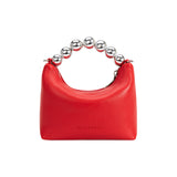 A small red recycled vegan leather crossbody bag with a silver beaded handle. 