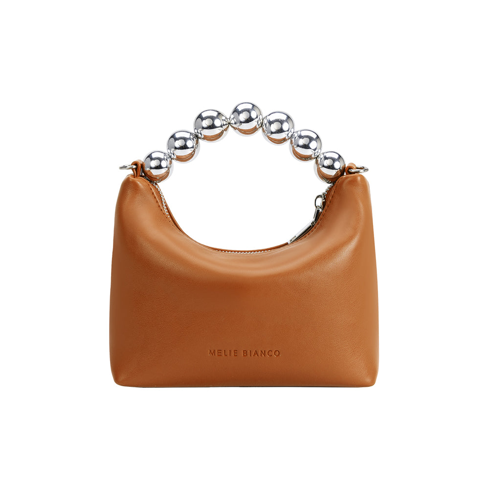 A small tan recycled vegan leather crossbody bag with a silver beaded handle. 