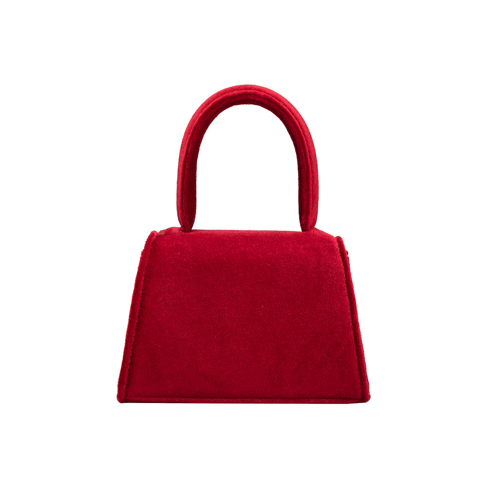 A mini red velvet top handle bag with a silver encrusted bow.
