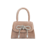 A mini taupe velvet top handle bag with a silver encrusted bow.