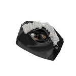 A medium velvet black top handle bag with a silver encrusted handle. 
