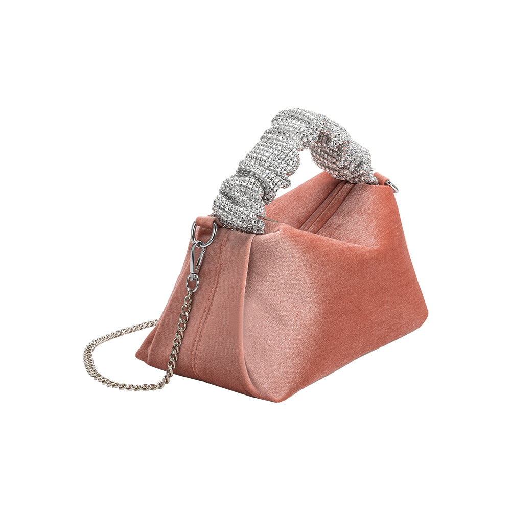 A medium velvet blush top handle bag with a silver encrusted handle. 