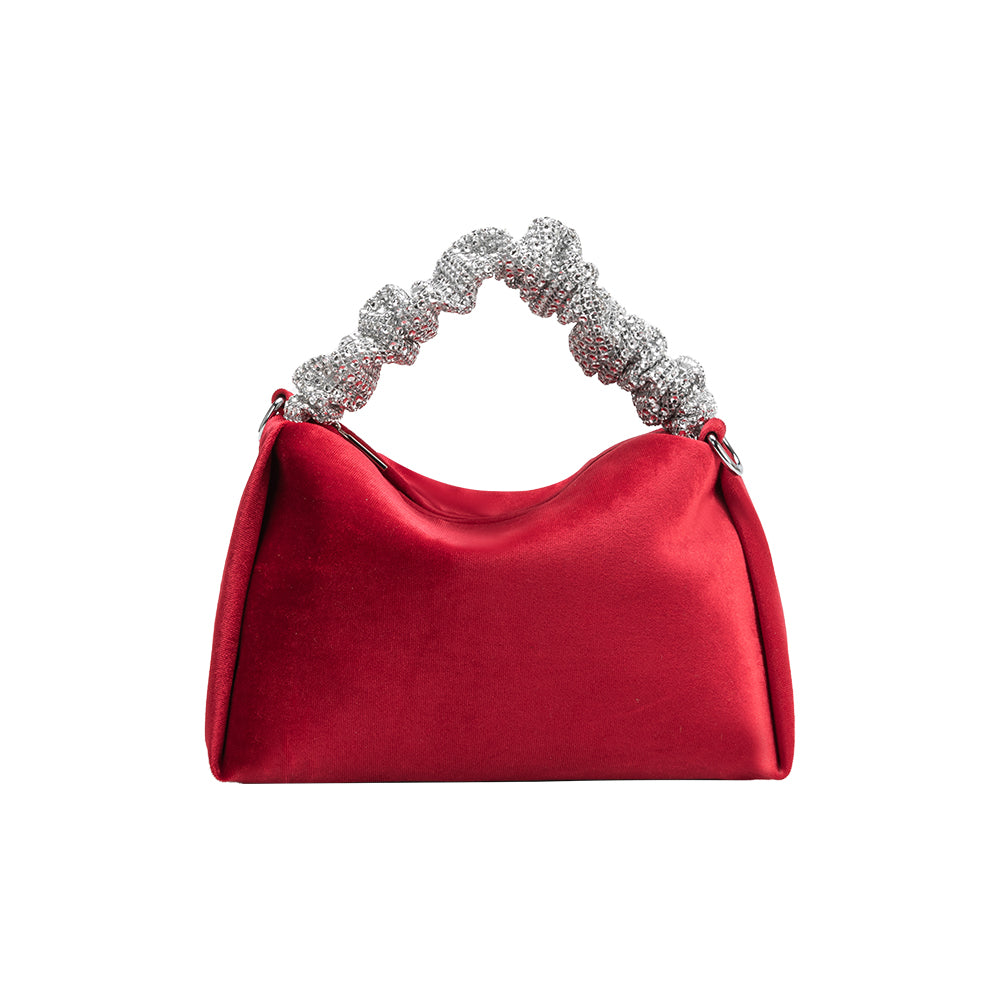 A medium velvet red top handle bag with a silver encrusted handle. 