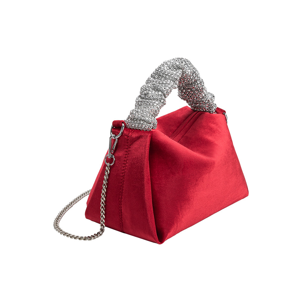 A medium velvet red top handle bag with a silver encrusted handle. 