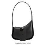 An iphone 14 pro size comparison image for a asymmetrical vegan leather structured shoulder bag.